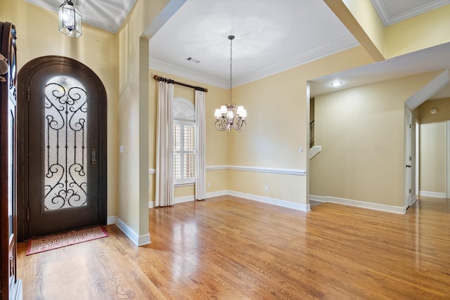 536 Warwick Willow Ln, Collierville, TN 38017 - entryway with light wood finished floors, ornamental molding, arched walkways, and a chandelier