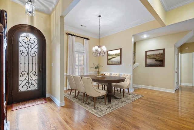 536 Warwick Willow Ln, Collierville, TN 38017 - foyer entrance with light wood finished floors, ornamental molding, arched walkways, and a chandelier