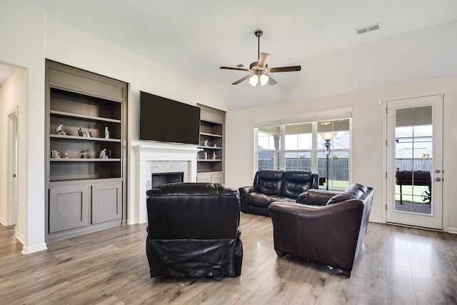 50 Misty Meadow Ln, Oakland, TN 38060 - living room with a fireplace, a ceiling fan, wood finished floors, vaulted ceiling, and built in shelves
