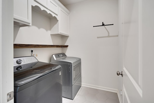 50 Misty Meadow Ln, Oakland, TN 38060 - laundry room with washing machine and dryer, cabinet space, and light tile patterned flooring