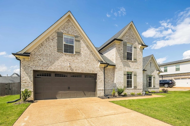 50 Misty Meadow Ln, Oakland, TN 38060 - view of front of property with brick siding, driveway, and an attached garage