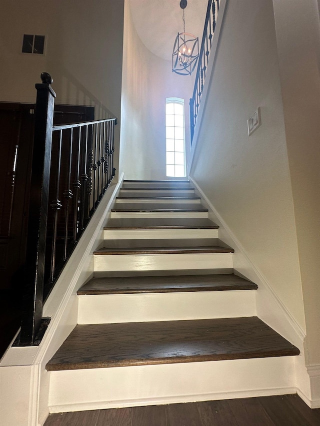 4689 Riva Ridge Dr, Olive Branch, MS 38654 - stairway featuring a chandelier and wood finished floors