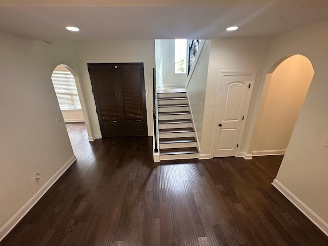4689 Riva Ridge Dr, Olive Branch, MS 38654 - hallway with arched walkways, dark wood finished floors, stairs, and recessed lighting