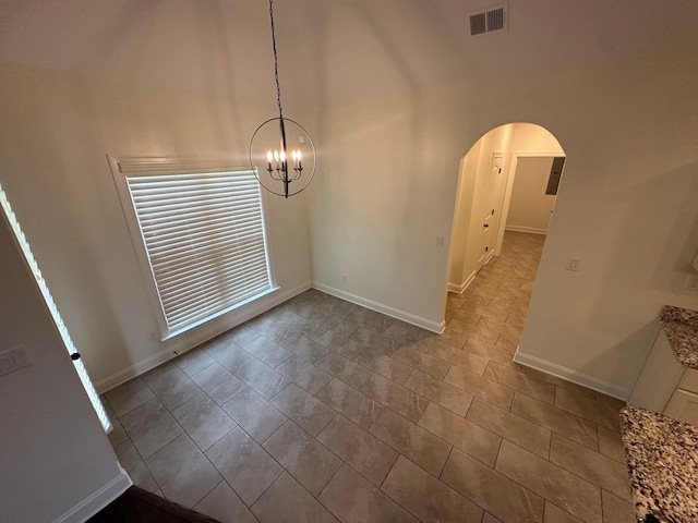 4689 Riva Ridge Dr, Olive Branch, MS 38654 - unfurnished room with a chandelier, arched walkways, and a towering ceiling