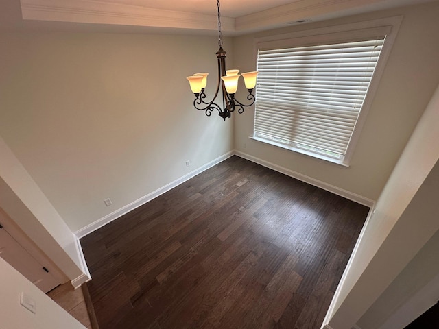 4689 Riva Ridge Dr, Olive Branch, MS 38654 - unfurnished dining area featuring dark wood-style flooring, ornamental molding, a tray ceiling, and a chandelier