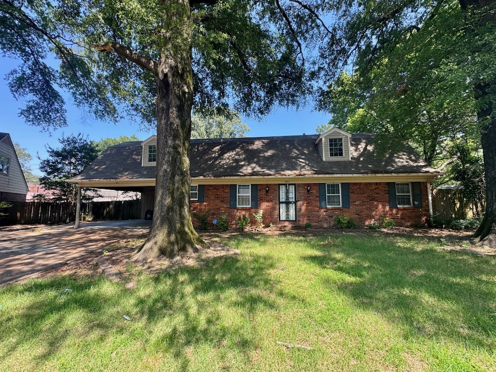 2987 Egan Dr, Memphis, TN 38115 - cape cod-style house with driveway, an attached carport, and brick siding