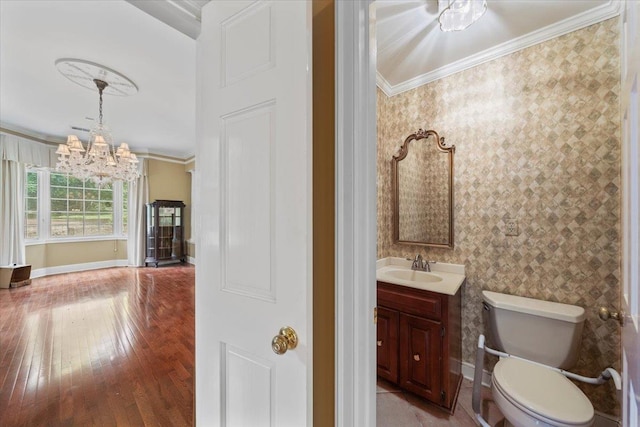 881 S Perkins Rd, Memphis, TN 38117 - bathroom with ornamental molding, a chandelier, vanity, and hardwood / wood-style floors