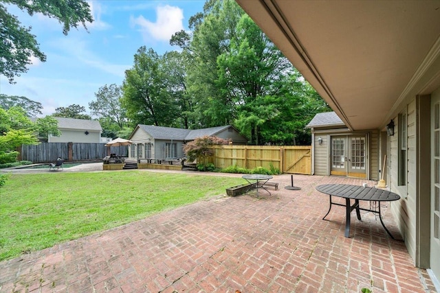 881 S Perkins Rd, Memphis, TN 38117 - fenced backyard with french doors and a patio area