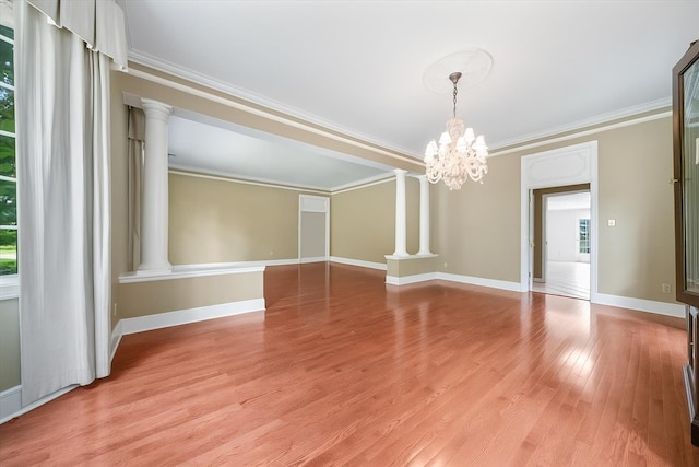 881 S Perkins Rd, Memphis, TN 38117 - unfurnished room with ornate columns, a chandelier, crown molding, and light wood-style flooring
