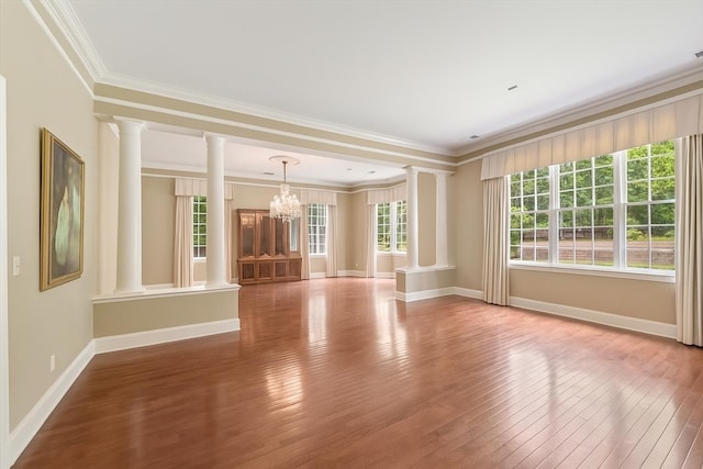 881 S Perkins Rd, Memphis, TN 38117 - unfurnished living room with ornate columns, a chandelier, hardwood / wood-style flooring, and ornamental molding