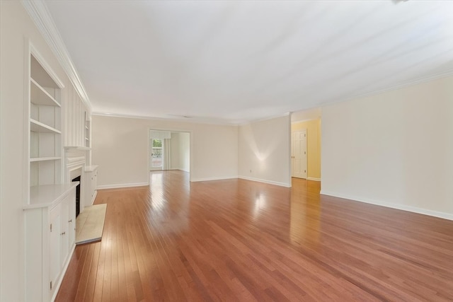 881 S Perkins Rd, Memphis, TN 38117 - unfurnished living room featuring light wood finished floors, crown molding, and a fireplace