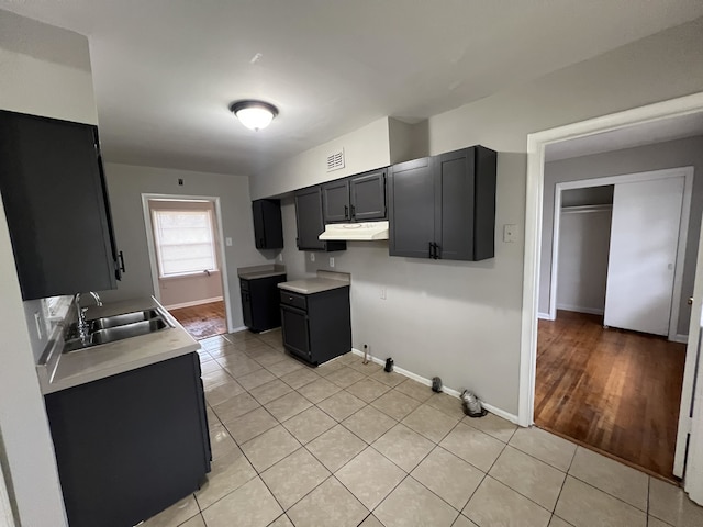 4267 Leroy Ave, Memphis, TN 38108 - kitchen with under cabinet range hood, light tile patterned floors, and light countertops