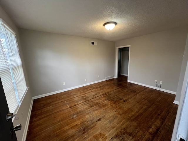 4267 Leroy Ave, Memphis, TN 38108 - spare room featuring dark wood finished floors and a textured ceiling