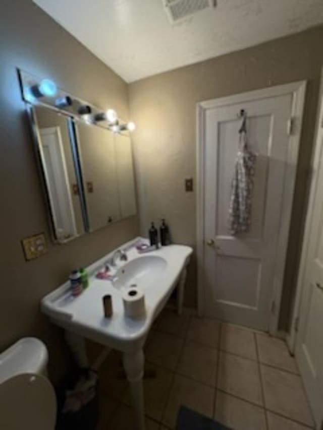 1235 Darlow St, Memphis, TN 38122 - half bath featuring tile patterned floors and toilet