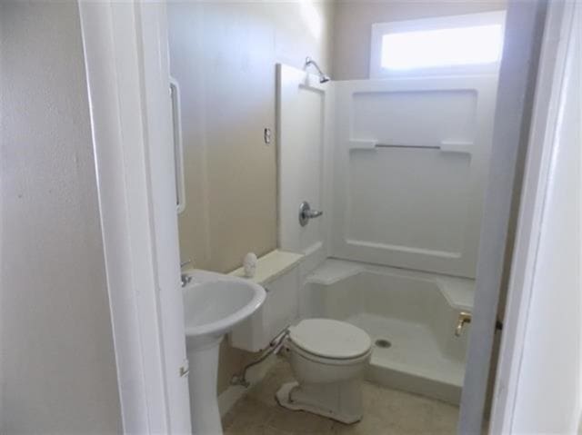 1106 Stratford Rd, Memphis, TN 38122 - bathroom with a stall shower and tile patterned flooring