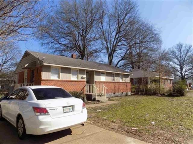 1106 Stratford Rd, Memphis, TN 38122 - view of property exterior with brick siding and a yard