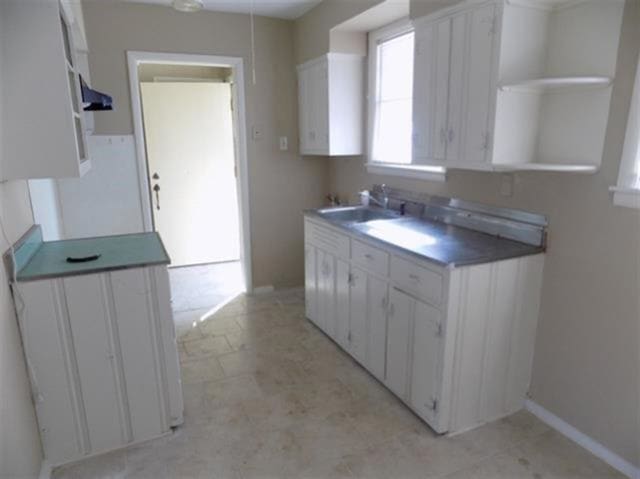 1106 Stratford Rd, Memphis, TN 38122 - kitchen featuring white cabinets, ventilation hood, and open shelves