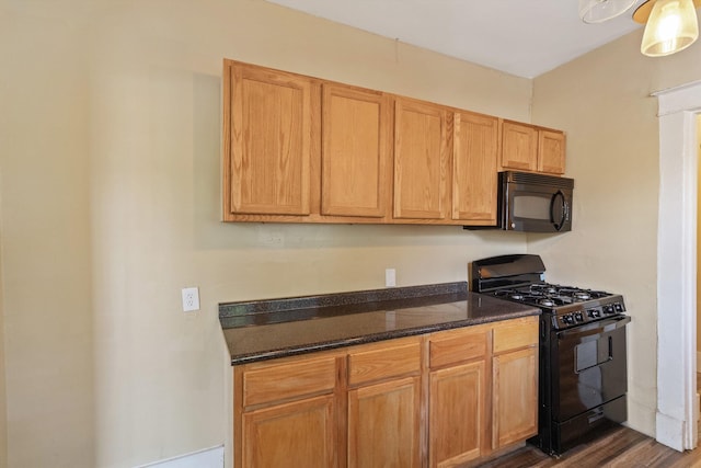 515 N Dunlap St, Memphis, TN 38105 - kitchen with black appliances, dark wood finished floors, and dark stone countertops