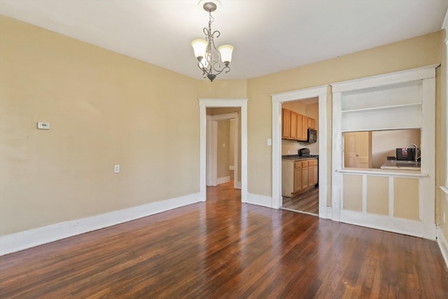 515 N Dunlap St, Memphis, TN 38105 - spare room with dark wood-type flooring, a chandelier, and built in features