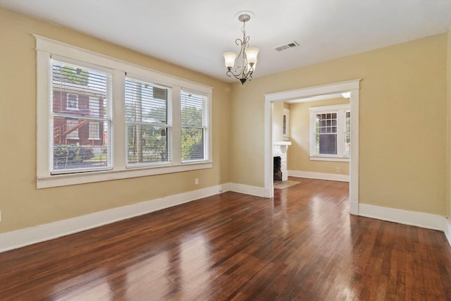 515 N Dunlap St, Memphis, TN 38105 - spare room with a chandelier, dark wood-type flooring, and a fireplace with flush hearth