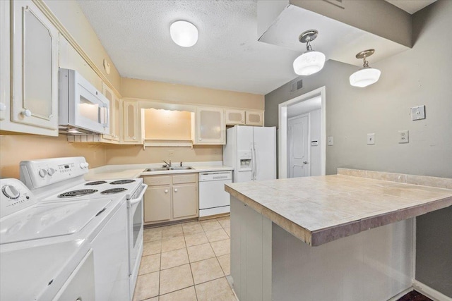 875 S Yates Rd Unit 4, Memphis, TN 38120 - kitchen featuring white appliances, washing machine and clothes dryer, light tile patterned floors, a textured ceiling, and pendant lighting