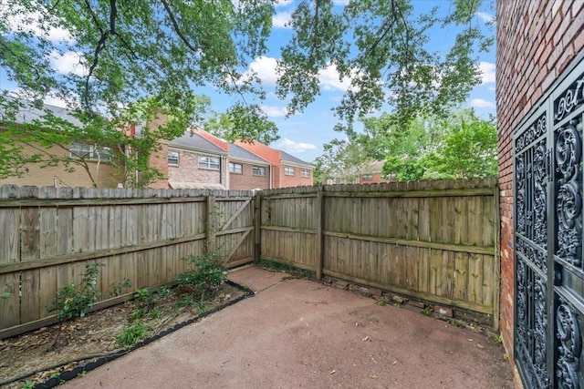 875 S Yates Rd Unit 4, Memphis, TN 38120 - fenced backyard with a patio and a gate