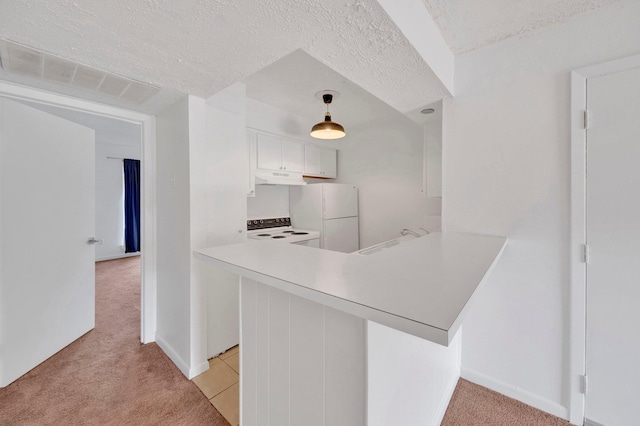 6787 Quail Hollow Ct Unit 4, Memphis, TN 38120 - kitchen with white appliances, under cabinet range hood, light carpet, a peninsula, and light countertops