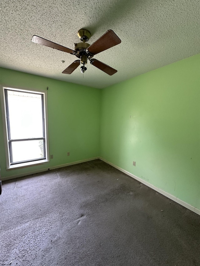 4607 Blue Willow Rd, Memphis, TN 38141 - spare room featuring a textured ceiling, a ceiling fan, and dark colored carpet