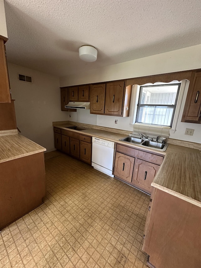 4607 Blue Willow Rd, Memphis, TN 38141 - kitchen with dishwasher, under cabinet range hood, light countertops, a textured ceiling, and light floors
