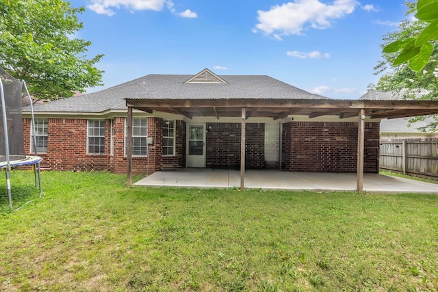10215 N Green Moss Dr, Cordova, TN 38018 - back of property featuring a trampoline, a patio, and brick siding