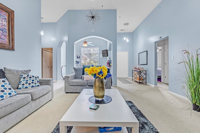 10215 N Green Moss Dr, Cordova, TN 38018 - living area with carpet flooring, a ceiling fan, arched walkways, and a high ceiling