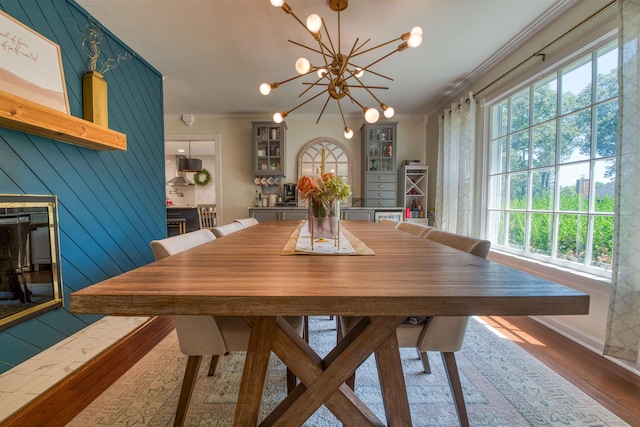 8986 Stratfield Cv, Germantown, TN 38139 - dining area with ornamental molding, plenty of natural light, wood finished floors, and a chandelier