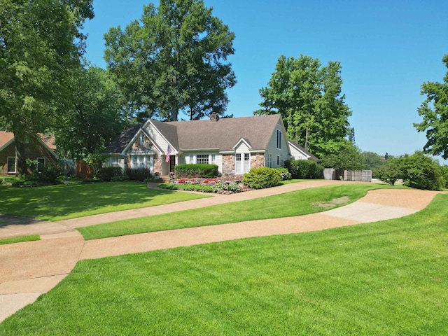 8986 Stratfield Cv, Germantown, TN 38139 - view of front of home with stone siding, a front yard, and a chimney