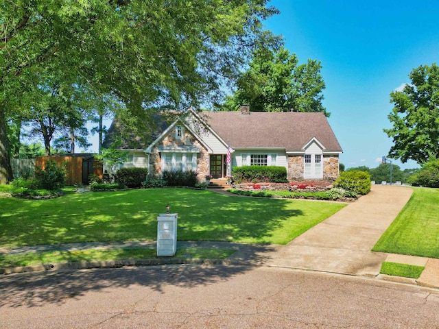 8986 Stratfield Cv, Germantown, TN 38139 - view of front of home featuring stone siding, a chimney, and a front yard