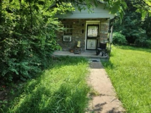 834 Crockett St, Memphis, TN 38107 - view of exterior entry featuring a lawn