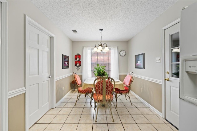 6445 Baird Ln, Bartlett, TN 38135 - dining room with a chandelier, light tile patterned floors, and a textured ceiling