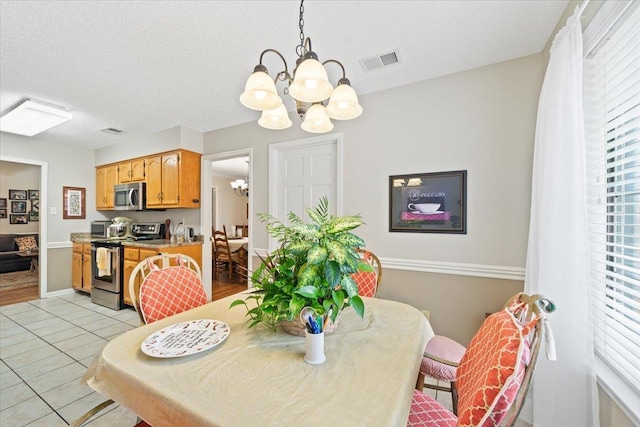 6445 Baird Ln, Bartlett, TN 38135 - dining space with a chandelier, plenty of natural light, and light tile patterned floors