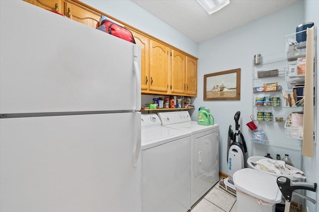 6445 Baird Ln, Bartlett, TN 38135 - laundry room featuring washer and clothes dryer, cabinet space, and light tile patterned floors