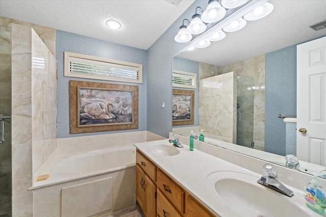 6445 Baird Ln, Bartlett, TN 38135 - bathroom featuring a textured ceiling, a bath, a stall shower, and double vanity
