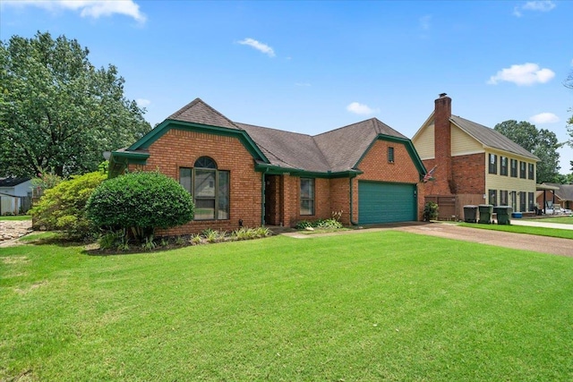 6445 Baird Ln, Bartlett, TN 38135 - view of front of home featuring brick siding, concrete driveway, a garage, and a front lawn