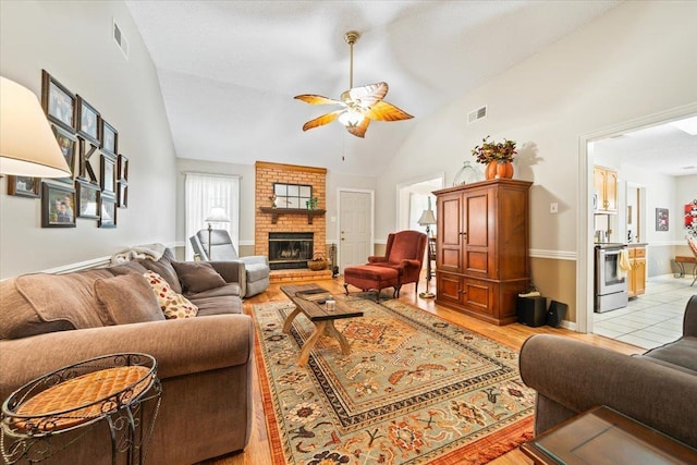 6445 Baird Ln, Bartlett, TN 38135 - living area with ceiling fan, high vaulted ceiling, light wood-style floors, and a fireplace