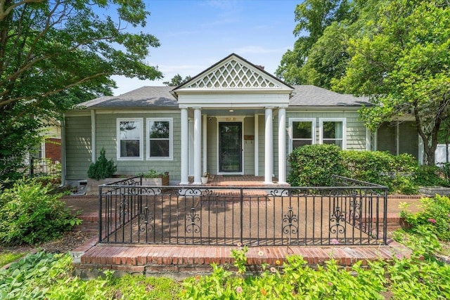 1978 Tutwiler Ave, Memphis, TN 38107 - view of front of house with covered porch, roof with shingles, and a fenced front yard