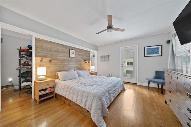1978 Tutwiler Ave, Memphis, TN 38107 - bedroom featuring light wood-style floors, access to outside, wooden walls, and ceiling fan