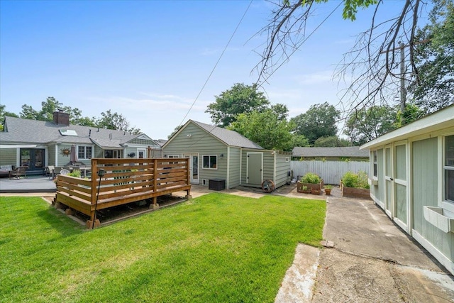 1978 Tutwiler Ave, Memphis, TN 38107 - rear view of house featuring a deck and a storage shed
