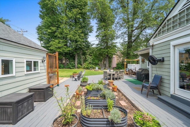 1978 Tutwiler Ave, Memphis, TN 38107 - wooden deck with outdoor dining area and a grill
