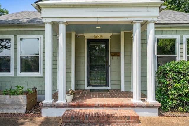 1978 Tutwiler Ave, Memphis, TN 38107 - doorway to property featuring roof with shingles and covered porch