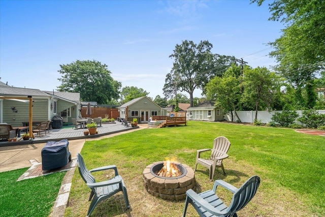 1978 Tutwiler Ave, Memphis, TN 38107 - view of yard featuring an outdoor fire pit and a wooden deck