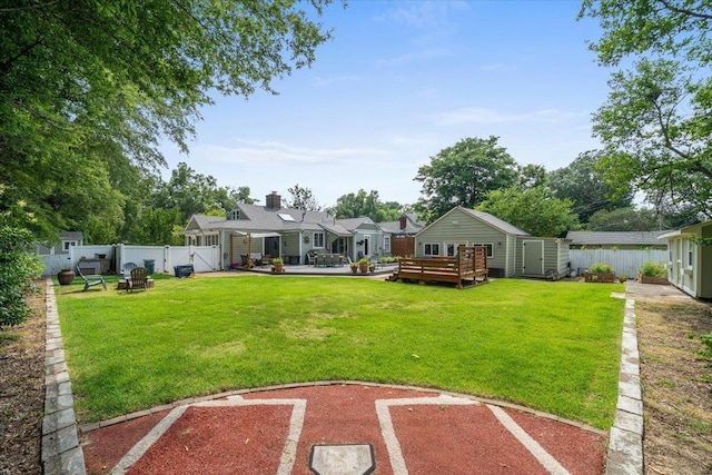 1978 Tutwiler Ave, Memphis, TN 38107 - fenced backyard with a storage unit, a deck, a gate, and a patio area