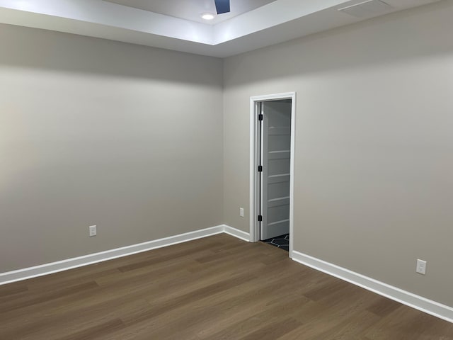 1998 Cloverdale Dr, Memphis, TN 38114 - spare room featuring dark wood finished floors, a tray ceiling, and ceiling fan