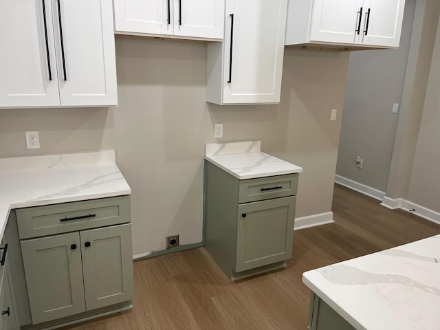 1998 Cloverdale Dr, Memphis, TN 38114 - kitchen with wood finished floors, light stone counters, and white cabinetry